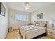 Bedroom with neutral tones, tile flooring, ceiling fan, and side table with lamp at 2280 World Parkway Blvd # 34, Clearwater, FL 33763