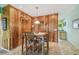 Dining area with wood paneling, a view into the kitchen and a four-chair dining set at 2280 World Parkway Blvd # 34, Clearwater, FL 33763