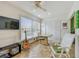 Florida Room featuring ceiling fan, table, seating, guitar and lots of light at 2280 World Parkway Blvd # 34, Clearwater, FL 33763