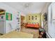 Bright Florida Room with a futon, guitar, dining table, and lots of light at 2280 World Parkway Blvd # 34, Clearwater, FL 33763