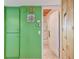 Hallway with green walls leads to a white-tiled bathroom with glass shower enclosure at 2280 World Parkway Blvd # 34, Clearwater, FL 33763