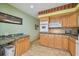 Bright kitchen featuring tiled countertops, cabinets, and modern appliances at 2280 World Parkway Blvd # 34, Clearwater, FL 33763