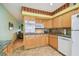 Well-lit kitchen featuring vintage countertops, wooden cabinetry and modern appliances at 2280 World Parkway Blvd # 34, Clearwater, FL 33763