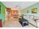 Bright living room featuring tile flooring and a dining area, with a cream-colored sofa at 2280 World Parkway Blvd # 34, Clearwater, FL 33763