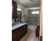 Bathroom with dual sinks, granite countertop, decorative mirror, and a separate tub/shower combo at 249 Iron Age St., Safety Harbor, FL 34695