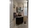 Stylish half-bath with vessel sink, round mirrors, and marble tile flooring, perfect for guests at 249 Iron Age St., Safety Harbor, FL 34695