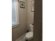 Cozy half-bath with toilet and window, offering a simple yet functional space for guests at 249 Iron Age St., Safety Harbor, FL 34695