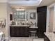 Bathroom featuring a dark vanity, glass bowl sink, granite counters, and a neutral color scheme at 249 Iron Age St., Safety Harbor, FL 34695