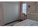 This bedroom boasts a spacious closet, a comfy chair, and a decorative dresser, all in a charming pink hue at 249 Iron Age St., Safety Harbor, FL 34695