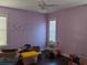 A spacious bedroom with lots of light from the windows, a ceiling fan, and hardwood flooring at 249 Iron Age St., Safety Harbor, FL 34695