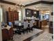 Dining room features a grand cabinet, chandelier, and bar area leading into the kitchen at 249 Iron Age St., Safety Harbor, FL 34695
