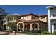 Charming two-story home featuring a terracotta roof, arched entry, and manicured landscaping at 249 Iron Age St., Safety Harbor, FL 34695