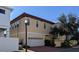 Rear exterior view of a two-story house with a brick driveway, a garage, and multiple windows at 249 Iron Age St., Safety Harbor, FL 34695