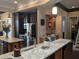 Gourmet kitchen boasts granite countertops, stainless steel appliances, and custom dark wood cabinetry at 249 Iron Age St., Safety Harbor, FL 34695