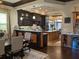 Open kitchen and dining area with granite counters, stainless appliances, and hardwood floors at 249 Iron Age St., Safety Harbor, FL 34695