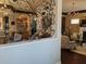 View of the living room through ornate wrought iron featuring staircase and kitchen in background at 249 Iron Age St., Safety Harbor, FL 34695