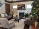 Bright living room features a fireplace, a decorative stone accent wall, and hardwood floors at 249 Iron Age St., Safety Harbor, FL 34695