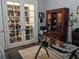 Comfortable office space featuring glass desk, wood cabinet, and French doors for light and separation at 249 Iron Age St., Safety Harbor, FL 34695