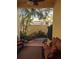 Inviting covered patio featuring comfortable seating, lush landscaping and brick flooring at 249 Iron Age St., Safety Harbor, FL 34695