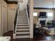 Staircase with iron railing and wood steps leading to a spacious living area, blending charm and functionality at 249 Iron Age St., Safety Harbor, FL 34695