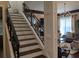 Elegant staircase featuring dark wood steps and decorative iron railing, adding a touch of sophistication at 249 Iron Age St., Safety Harbor, FL 34695