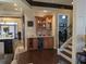 The wet bar area features custom cabinetry, a wine fridge, and decorative backsplash at 249 Iron Age St., Safety Harbor, FL 34695