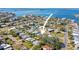 Aerial view of a coastal neighborhood showcasing charming homes, lush greenery, and access to tranquil waterways at 2491 Coronado Way, Dunedin, FL 34698