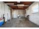 Unfinished basement featuring a utility sink, exposed beams, and concrete flooring, offering potential for customization at 2491 Coronado Way, Dunedin, FL 34698