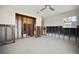 A spacious living room awaits renovation, offering a ceiling fan and bright natural light at 2491 Coronado Way, Dunedin, FL 34698