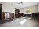 Partially renovated living room space with a light colored tile floor and a large window at 2491 Coronado Way, Dunedin, FL 34698