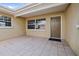 Outdoor entrance with a covered patio and an entrance door with a tile floor at 2491 Coronado Way, Dunedin, FL 34698