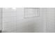 New white subway tile shower niche with a silver trim at 2491 Coronado Way, Dunedin, FL 34698