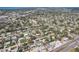 Aerial view of single Gathering homes, lawns, pools, mature trees and a street in a residential neighborhood at 2851 66Th N Way, St Petersburg, FL 33710