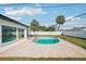 This backyard features a pool, patio, and is surrounded by lush landscaping and a privacy fence at 2851 66Th N Way, St Petersburg, FL 33710