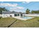 This spacious backyard features a pool and is surrounded by lush landscaping and a privacy fence at 2851 66Th N Way, St Petersburg, FL 33710
