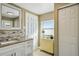 Bathroom featuring a white sink with granite countertops, a mosaic tile backsplash, and an open doorway at 2851 66Th N Way, St Petersburg, FL 33710