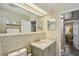 Bathroom featuring a sink with granite countertops, a wall mirror, and an open doorway to another room at 2851 66Th N Way, St Petersburg, FL 33710