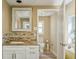 Bathroom featuring a white sink with granite countertops, a mosaic tile backsplash, and an open doorway at 2851 66Th N Way, St Petersburg, FL 33710