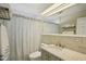Bathroom featuring a shower with a curtain, granite countertops, and a neutral color scheme, creating a soothing space at 2851 66Th N Way, St Petersburg, FL 33710