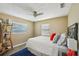 This primary bedroom features a ceiling fan, plank flooring, and a large window for natural light at 2851 66Th N Way, St Petersburg, FL 33710