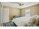 Bedroom with a ceiling fan, a large bed with a patterned blue rug underneath, and a window offering natural light at 2851 66Th N Way, St Petersburg, FL 33710