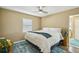 Bedroom with a ceiling fan, a large bed with a patterned blue rug underneath, and a window offering natural light at 2851 66Th N Way, St Petersburg, FL 33710