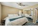 Bedroom with a ceiling fan, mirrored closet doors, and a large bed with a patterned blue rug underneath at 2851 66Th N Way, St Petersburg, FL 33710