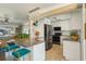 Kitchen with a granite island, stainless steel appliances, and seamless flow to the living room at 2851 66Th N Way, St Petersburg, FL 33710