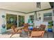 This covered outdoor lanai features comfortable seating and serene views of the backyard at 2851 66Th N Way, St Petersburg, FL 33710