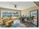 Inviting living room with large windows offering backyard views with a pool and plenty of natural light at 2851 66Th N Way, St Petersburg, FL 33710