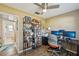 Office with a ceiling fan, a desk with multiple monitors, a bookcase full of books and an ergonomic chair at 2851 66Th N Way, St Petersburg, FL 33710