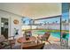 Relax on the patio with comfortable seating and serene views of the pool and lush landscaping at 2851 66Th N Way, St Petersburg, FL 33710