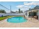 The backyard features a large in-ground pool, a patio, and is surrounded by lush landscaping at 2851 66Th N Way, St Petersburg, FL 33710
