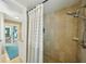 The renovated shower features stone tiling, a rainfall shower head and opens to the lanai at 2851 66Th N Way, St Petersburg, FL 33710